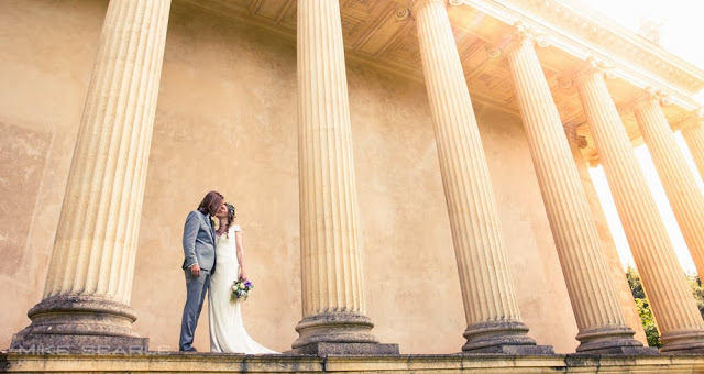 Fine art wedding photograph of a couple under columns 